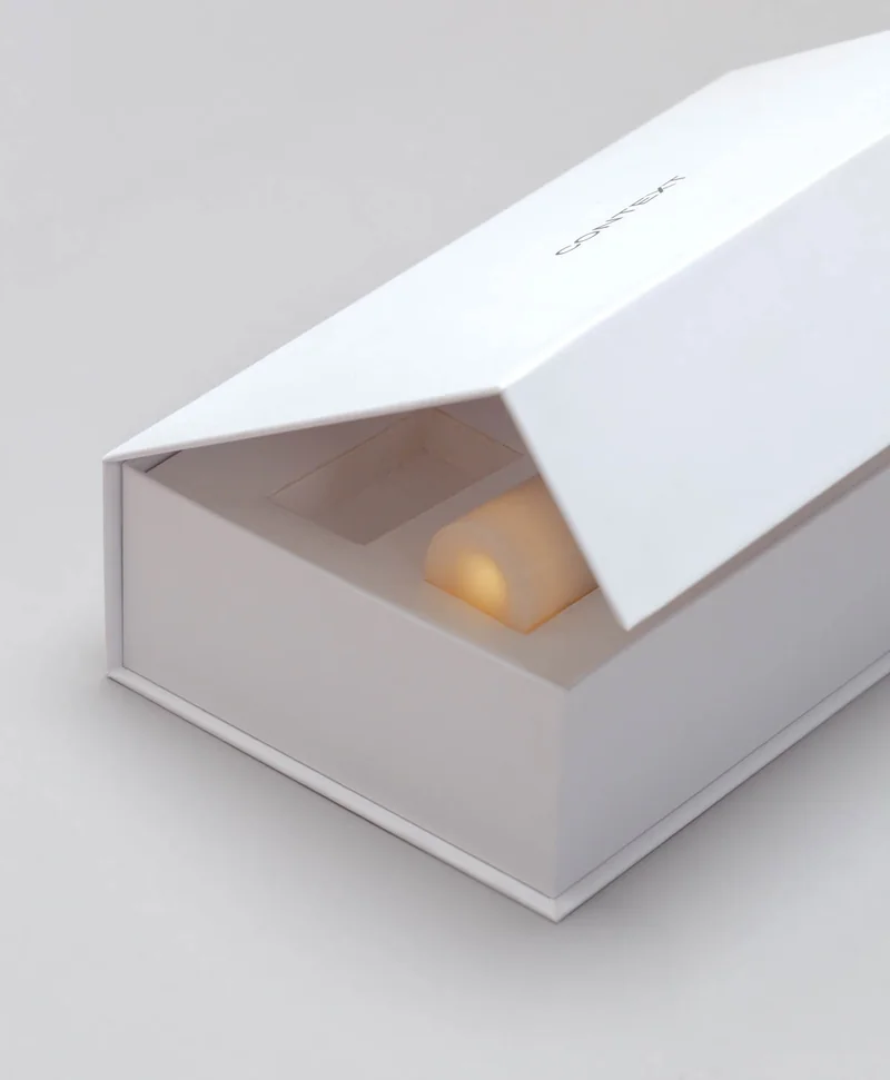 The presentation box with its lid lifted to reveal a Context candle