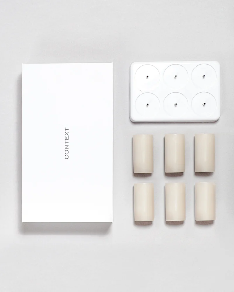 The complete Context set: six wax candles and the six-position USB dock beside the presentation box